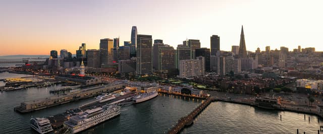 Aerial view of San Francisco skyline and Embarcadero waterfront at sunset